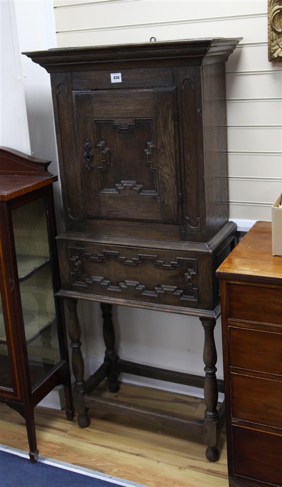A 17th century style oak cabinet on stand, H.157cm
